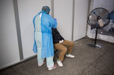 A nurse practitioner swabs a patient at a Covid-19 testing center in Brooklyn, New York