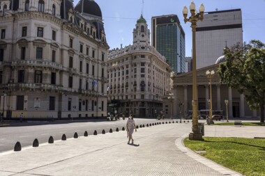 Woman with a mask on walking on the sidewalk in Argentina