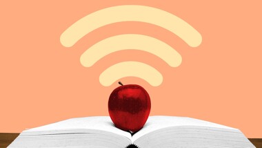 An apple sitting on a book with a wifi symbol radiating upwards