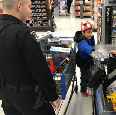 Kid at cash register with police officer