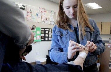 Richland student bandaging a person’s foot