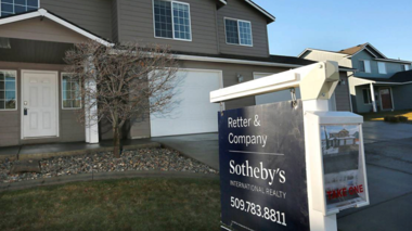 house with southeby's sale sign in front