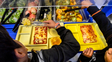 student with lunch tray