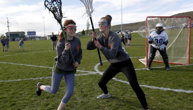 Young women playing lacrosse