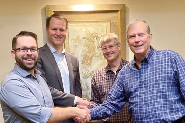 Chris Porter, Walter Kinney, and the Marple brothers, Bob jr. and Steve, shaking hands