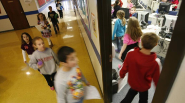 long exposure photo of elementary students walking into their classroom