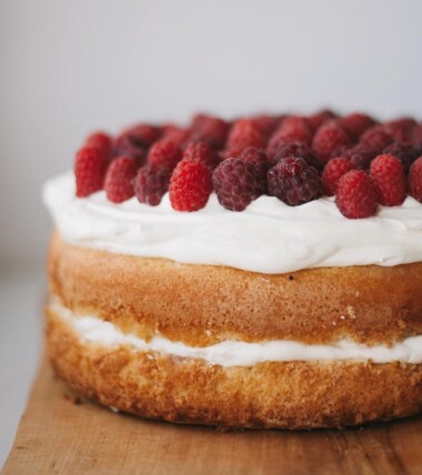 A raspberry topped cake with buttercream filling
