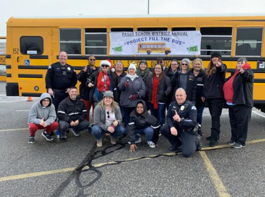 school bus with volunteers in front