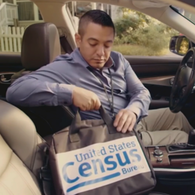 man in car grabbing for bag that reads us census bureau
