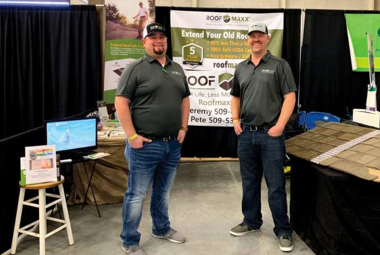 Two men standing in front of business display