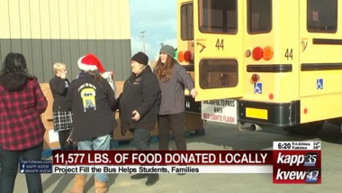 school bus with people standing behind it