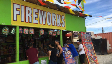 People purchasing fireworks from a stand