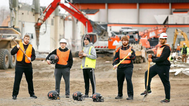 Kennewick Lions football players holding tools