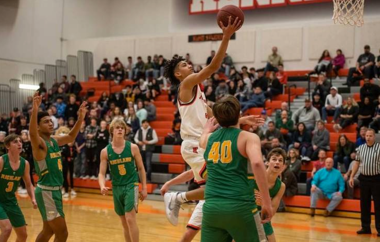 Kennewick high basketball player goes for a layup surrounded by Richland High players