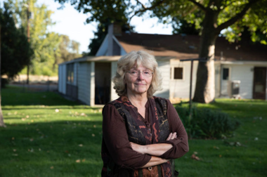 Linda Cameron standing in her front yard