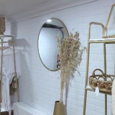 mirror, plant and shelves inside Theory Boutique