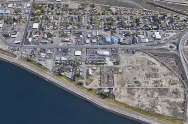 aerial shot of businesses and buildings along a river line