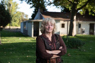 Linda Cameron standing in her front yard