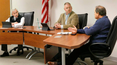 Benton commissioners sitting at a table in a meeting