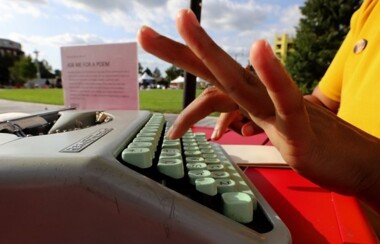 Hand typing on typewriter
