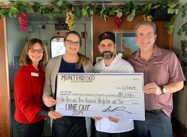 Monterossos staff holding novelty check for DINE OUT day