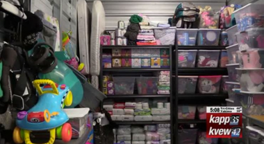 Shelves full of plastic bins and items for kids