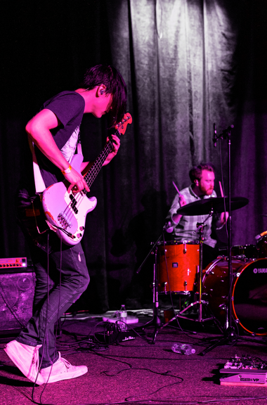 Guitarist and drummer playing live