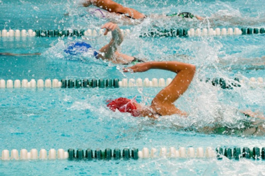 swimmer swims through pool