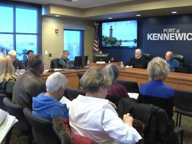 people sitting in chairs indoors during a Port of Kennewick meeting