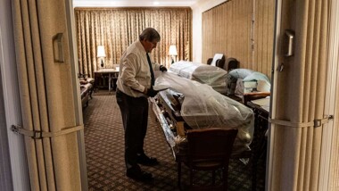 Funeral Director Joe Neufeld inventories the bodies of coronavirus victims bound for burial, in the main chapel of the Gerard J. Neufeld Funeral Home in Queens, New York, April 26, 2020.
