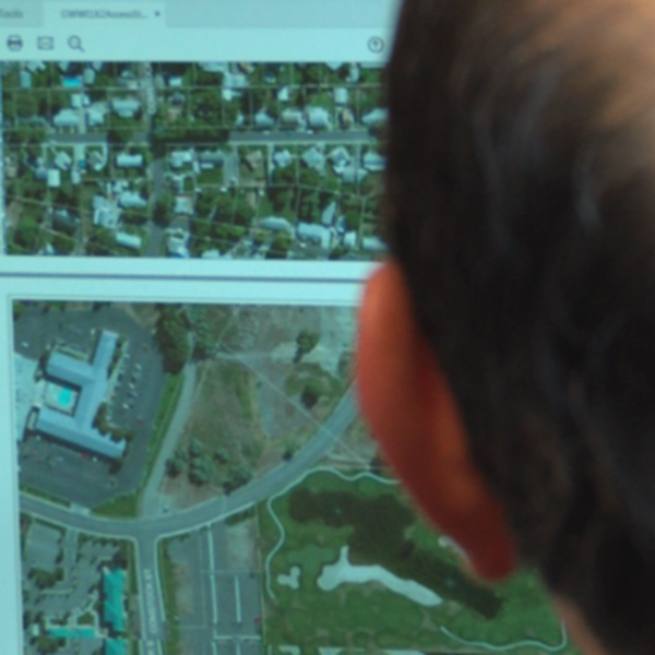 Child stares at computer image of street