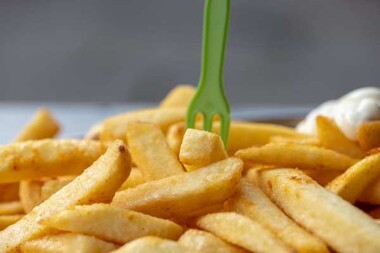french fries with a green fork in them