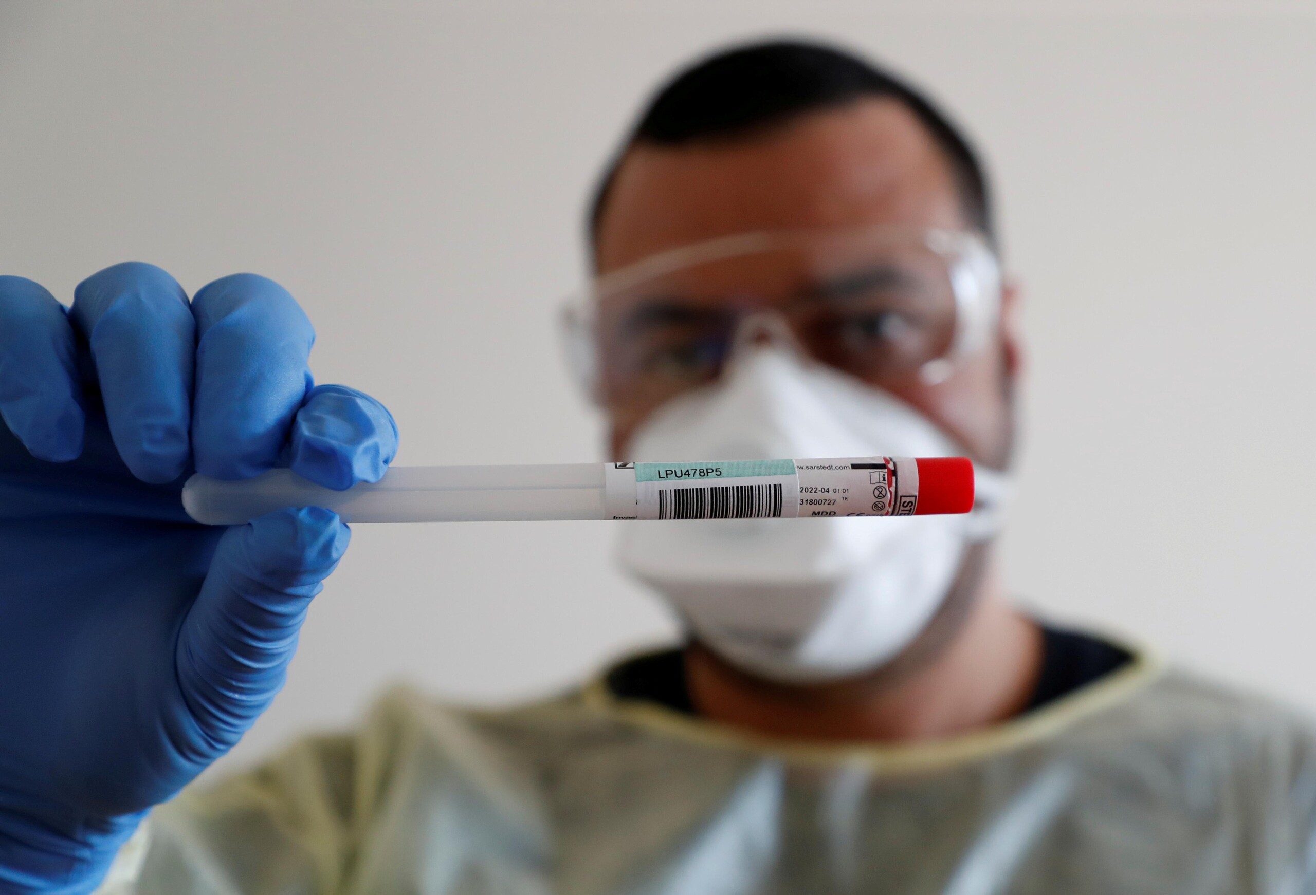 A member of the medical staff shows a used sample container at a test centre for coronavirus disease (COVID-19) at Havelhoehe community hospital in Berlin, Germany, April 6, 2020