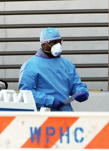 Person in protective clothing wearing a mask and goggles